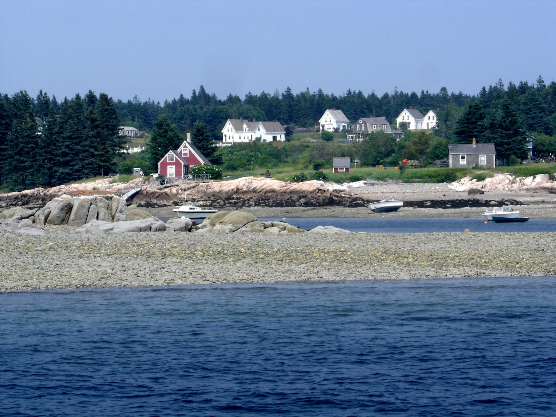 a group of people standing next to a body of water