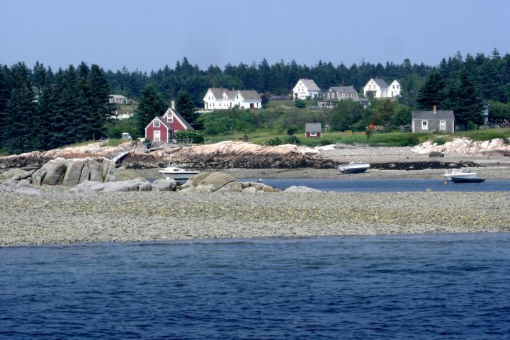 a group of people standing next to a body of water