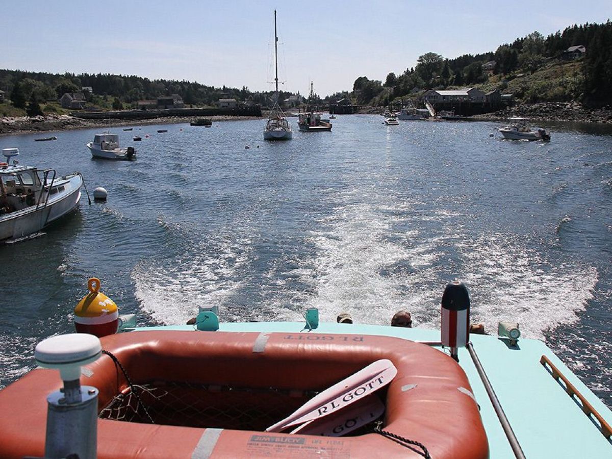 a boat is docked next to a body of water