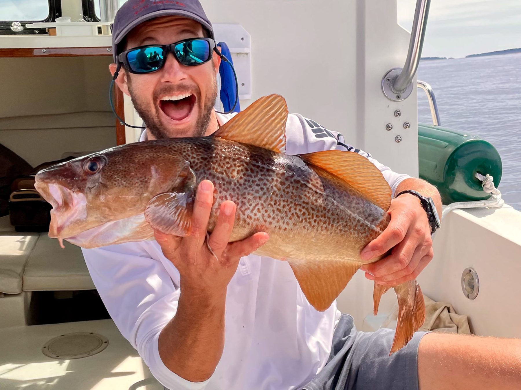Captain Matt holding a fish on a boat