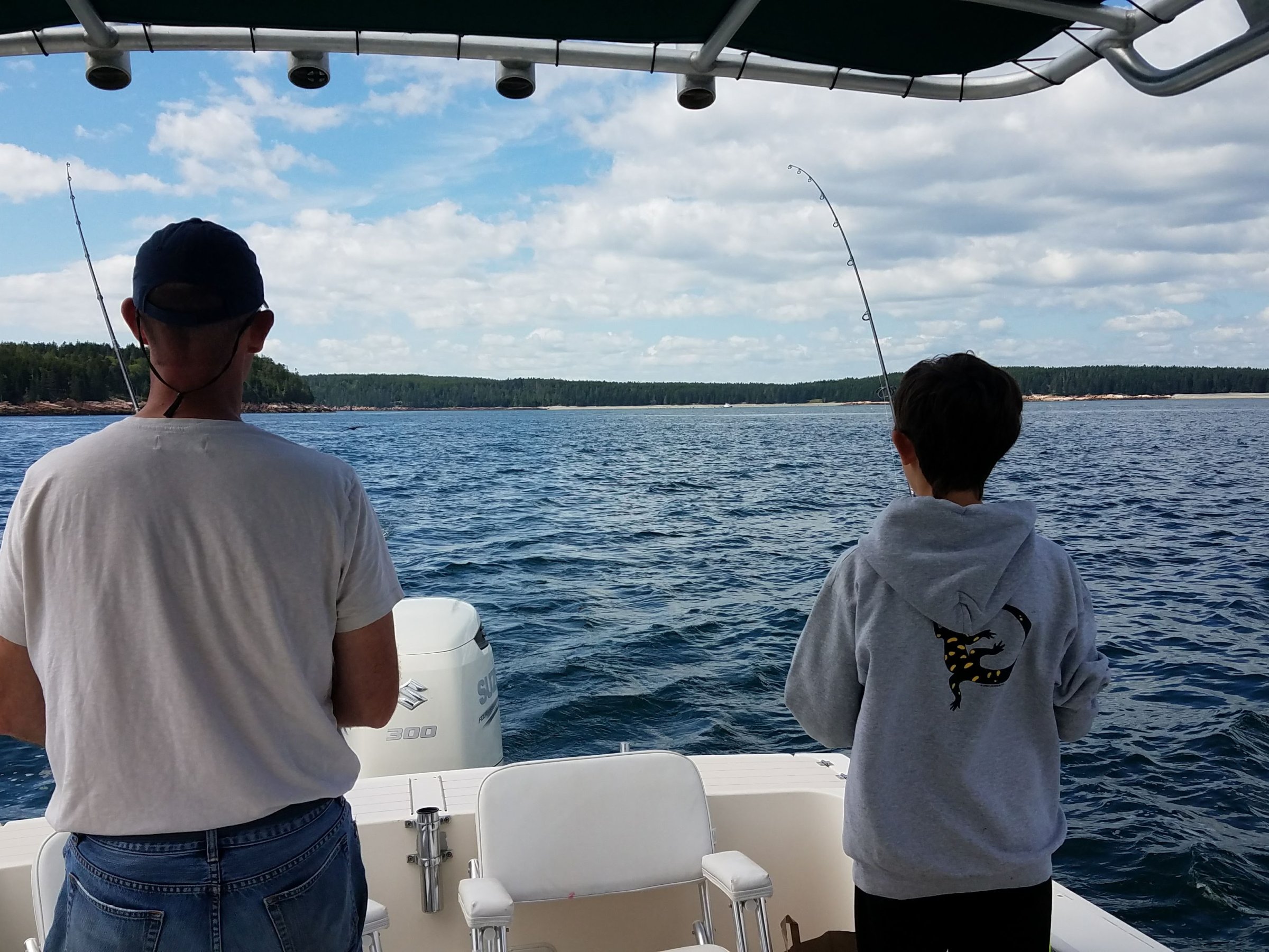 a man fishing on a boat in the water